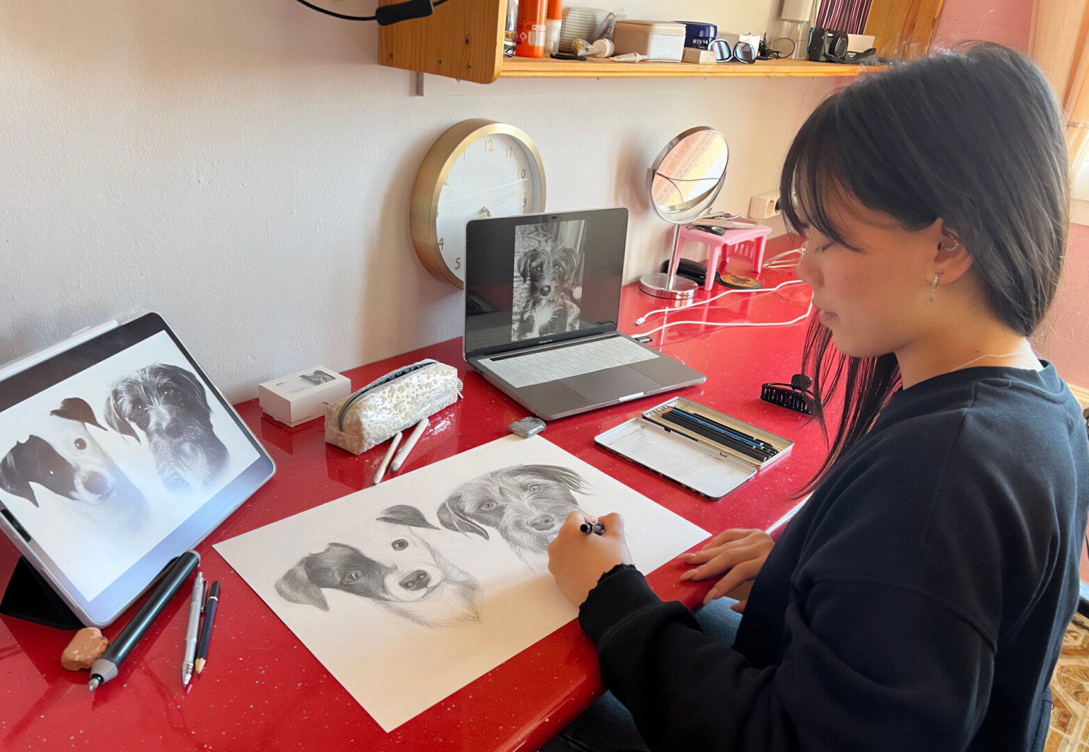 Meili drawing a portrait of two dogs